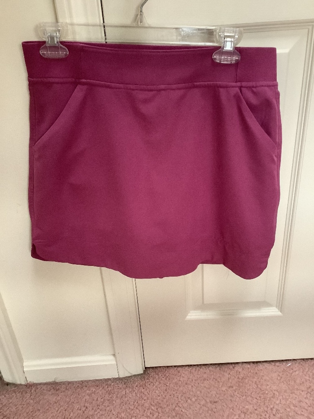 Raspberry colored skirt with hidden shorts. Size smaller